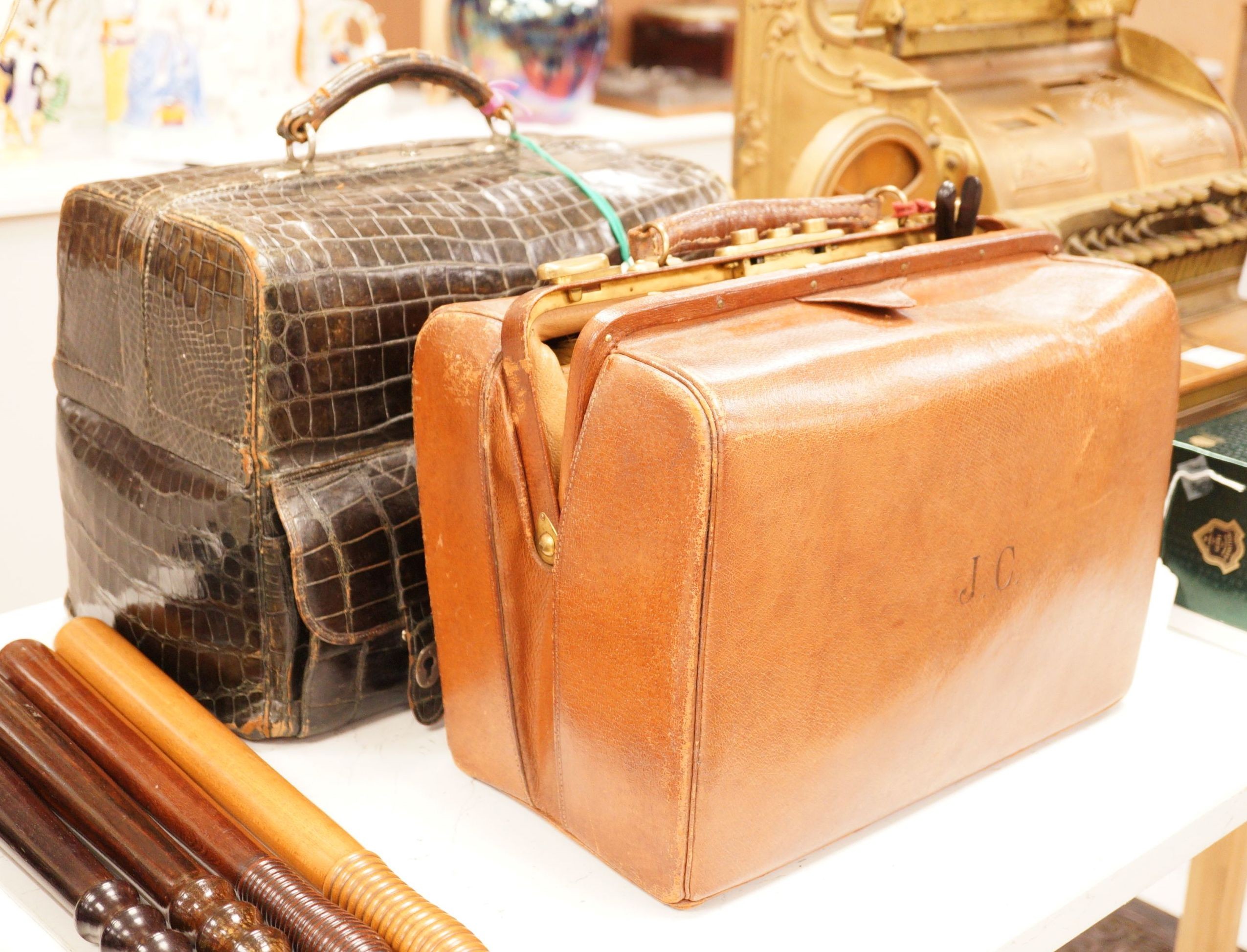 A Drew & Sons Leadenhall St. faux green crocodile gentleman’s vanity case including silver mounted glass jars etc. and a leather gentleman’s case